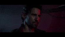a close up of a man 's face with a red light on his face