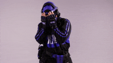 a person wearing a purple mask and gloves covering their eyes