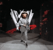 a man in a suit and tie with a pig in a space helmet on his head
