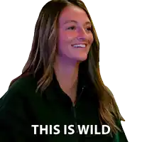 a woman in a black jacket smiles with the words this is wild behind her