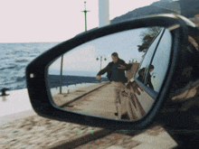 a man is reflected in the rear view mirror of a vehicle