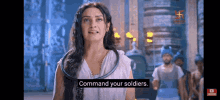 a woman in a white dress is standing in front of a group of soldiers and saying `` command your soldiers '' .