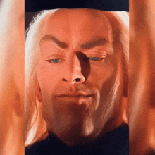 a close up of a man 's face with his eyes closed