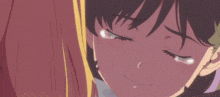 a close up of a girl 's face with a tear running down her face .