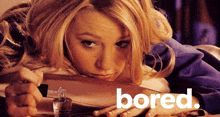 a woman laying on a table with the word bored in the corner