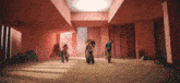 a group of people are standing in a room with a pink wall