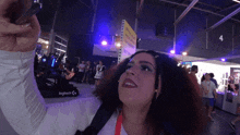 a woman taking a selfie with a sign that says logitech on it