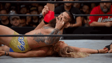 a wrestler wearing gold shorts with the word sodo on the side