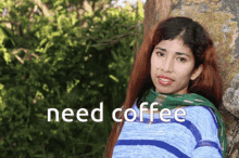 a woman leaning against a tree with the words need coffee written above her