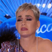 a close up of a woman 's face with a blue background that says american idol
