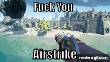 a person is holding a gun in front of a castle on a beach .