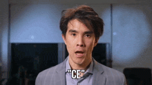a man in a suit is saying " ce "