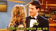 a man in a tuxedo is talking to a woman who says i do n't care where we are