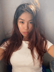 a woman taking a selfie with a white shirt on