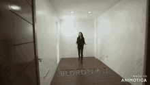 a woman is standing in an empty bedroom with the words bedroom 3 written on the wall