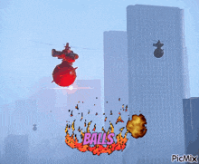 a picture of a helicopter flying over a city with the word balls written on it