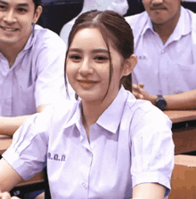 a girl wearing a shirt with the letters n.a.n. on the collar