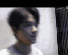 a blurry picture of a man 's face and neck
