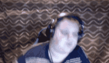 a man wearing headphones and a blue shirt