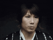 a woman with short hair is wearing a black and white shirt