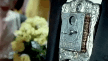 a close up of a lock with the number 9 on it in front of flowers