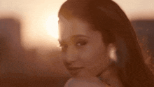 a close up of a woman 's face with the sun shining on her face .
