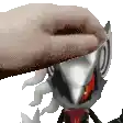 a close up of a person 's hand petting a sonic the hedgehog figurine .