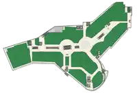 an aerial view of a shopping mall with green areas