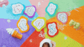 colorful clocks with roman numerals on them are laying on a table