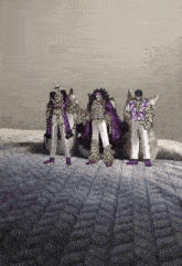 a pixel art of three people standing next to each other on a blanket