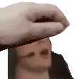 a close up of a person 's hand covering their face .