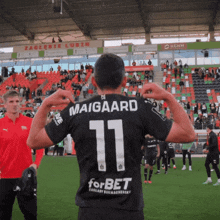 a soccer player with the name maigaard on his back
