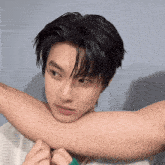 a close up of a person 's arm with a blue background
