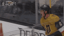 a hockey player celebrates a goal during the 3rd period