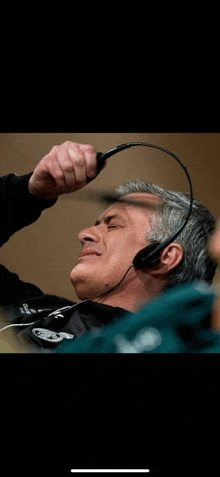 a man wearing headphones with the word eagles on it