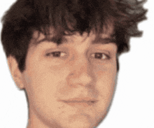a close up of a young man 's face with a serious look on his face .