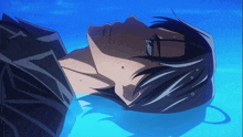 a man in a black shirt is laying down in the water