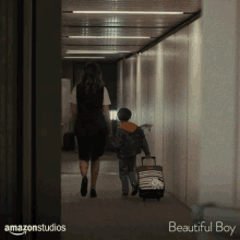 a woman and a child are walking down a hallway with the words beautiful boy on the bottom