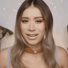 a close up of a woman wearing a choker necklace