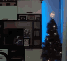 a christmas tree is lit up in a living room