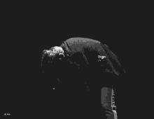 a black and white photo of a man holding his hand to his forehead