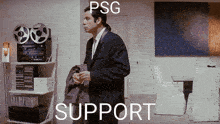 a man in a suit and tie is standing in a room with the words psg support written on the bottom