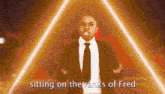 a man in a suit and tie is sitting on the rank of fred