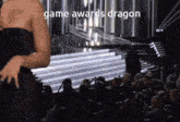 a woman in a black dress is standing in front of a crowd at a game awards dragon event