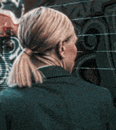 a woman in a ponytail stands in front of a wall that has graffiti on it