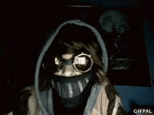 a person wearing a mask and sunglasses is making a funny face .