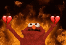elmo from sesame street is holding two broken hearts in front of a fire background