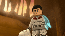 a lego figure with a glowing arm is standing in front of a building