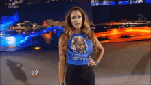 a woman wearing a shirt that says teddy is standing with her hands on her hips