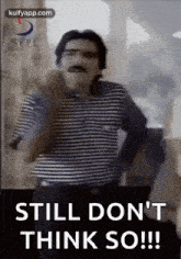 a man with a mustache and glasses is standing in front of a door and says `` still don 't think so !! ''